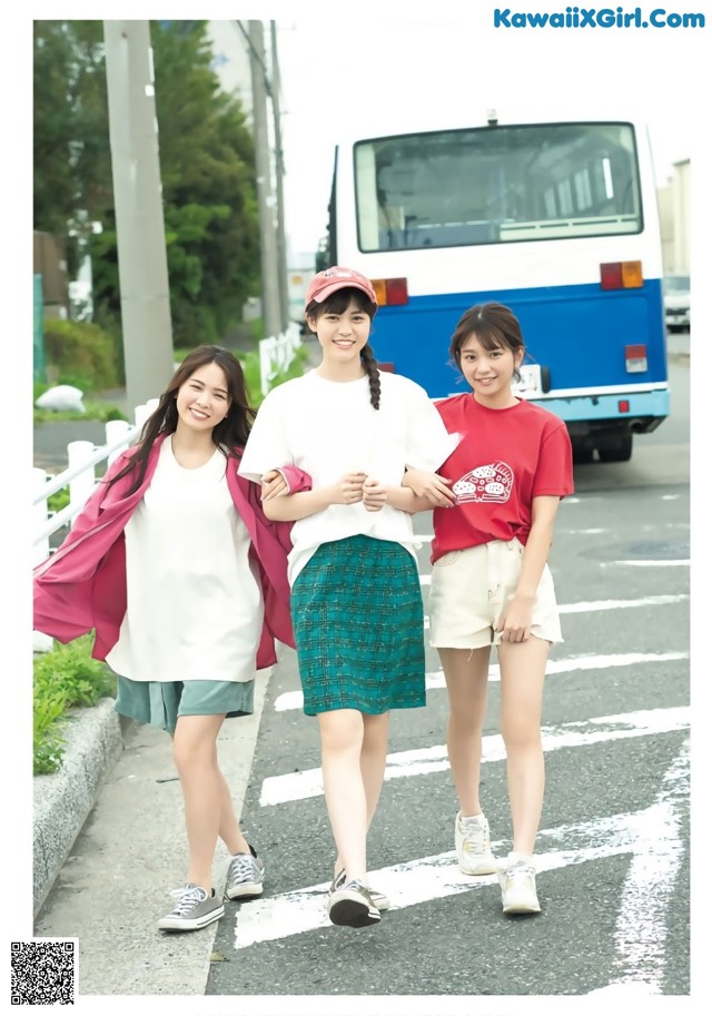 A group of young women walking across a street.