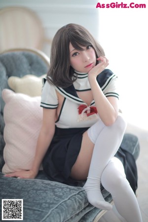 A woman in lingerie sitting on a couch.