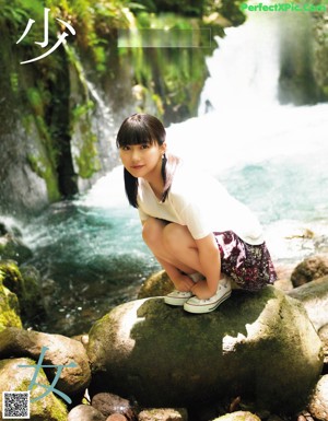 A woman in a white shirt is posing for a magazine cover.