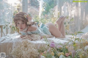 A woman sitting on top of a bed in lingerie.