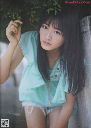A woman with long black hair and bangs is posing for a picture.
