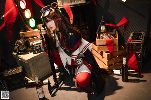 A woman in a red and black outfit holding a sword.