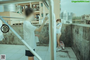 A man and a woman standing next to each other in front of a wall.