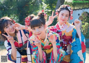 A group of three young women sitting next to each other.