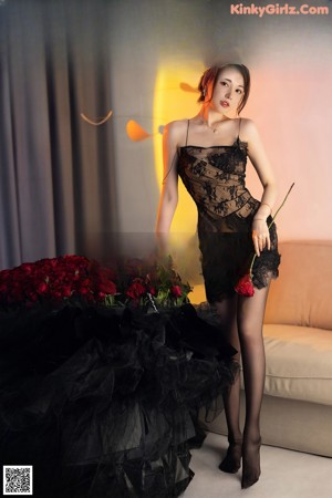 A woman in a white dress posing for a picture.